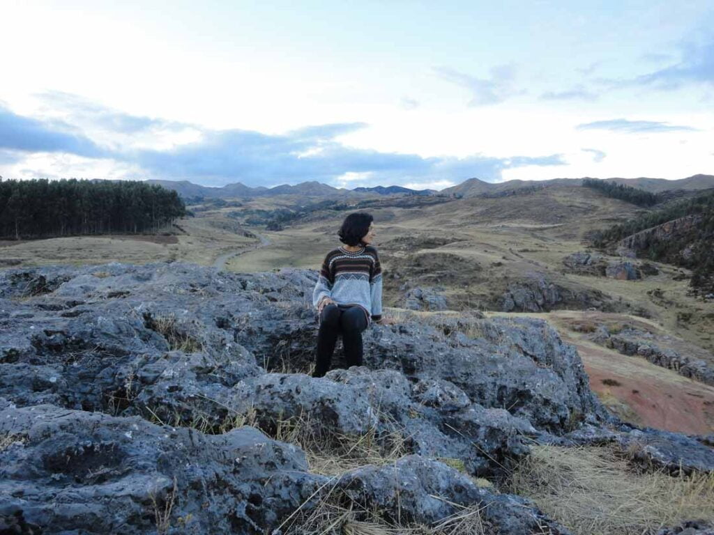 Image of me looking looking out at a wide open rocky landscape in the Peruvian Andes.