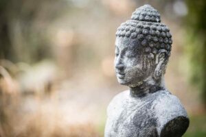 Knowledge of the panchakosha (the five layers of the Self) will help you go inward and establish yourself in the peace within. Image of a stone Buddha.